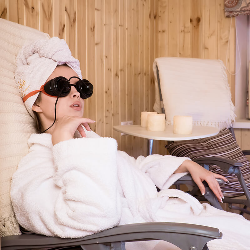Woman relaxing with eye therapy glasses at spa in Business Bay Dubai
